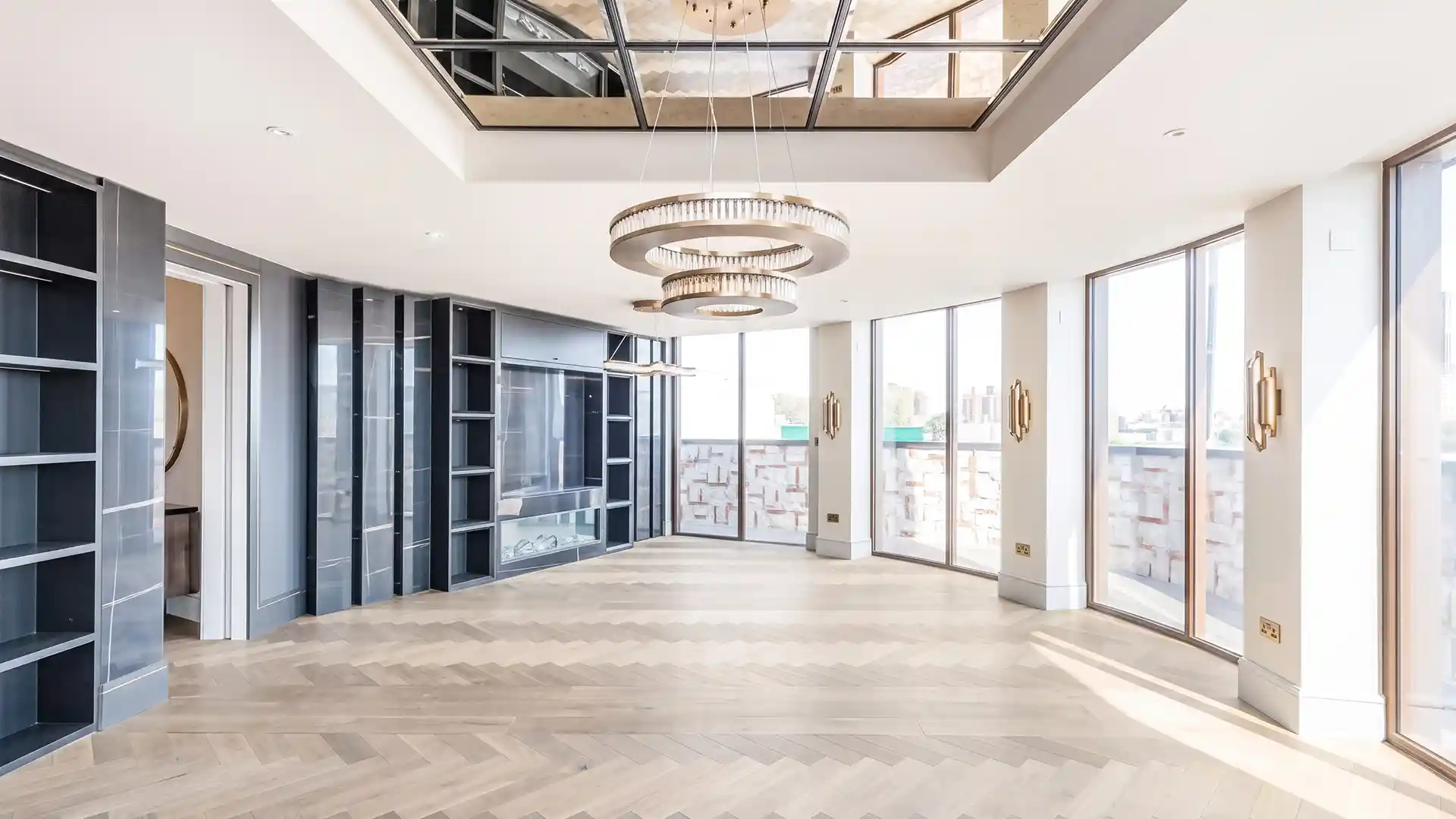 Modern luxury living room featuring bespoke joinery, herringbone flooring, and custom interior finishes by Solmaz UK